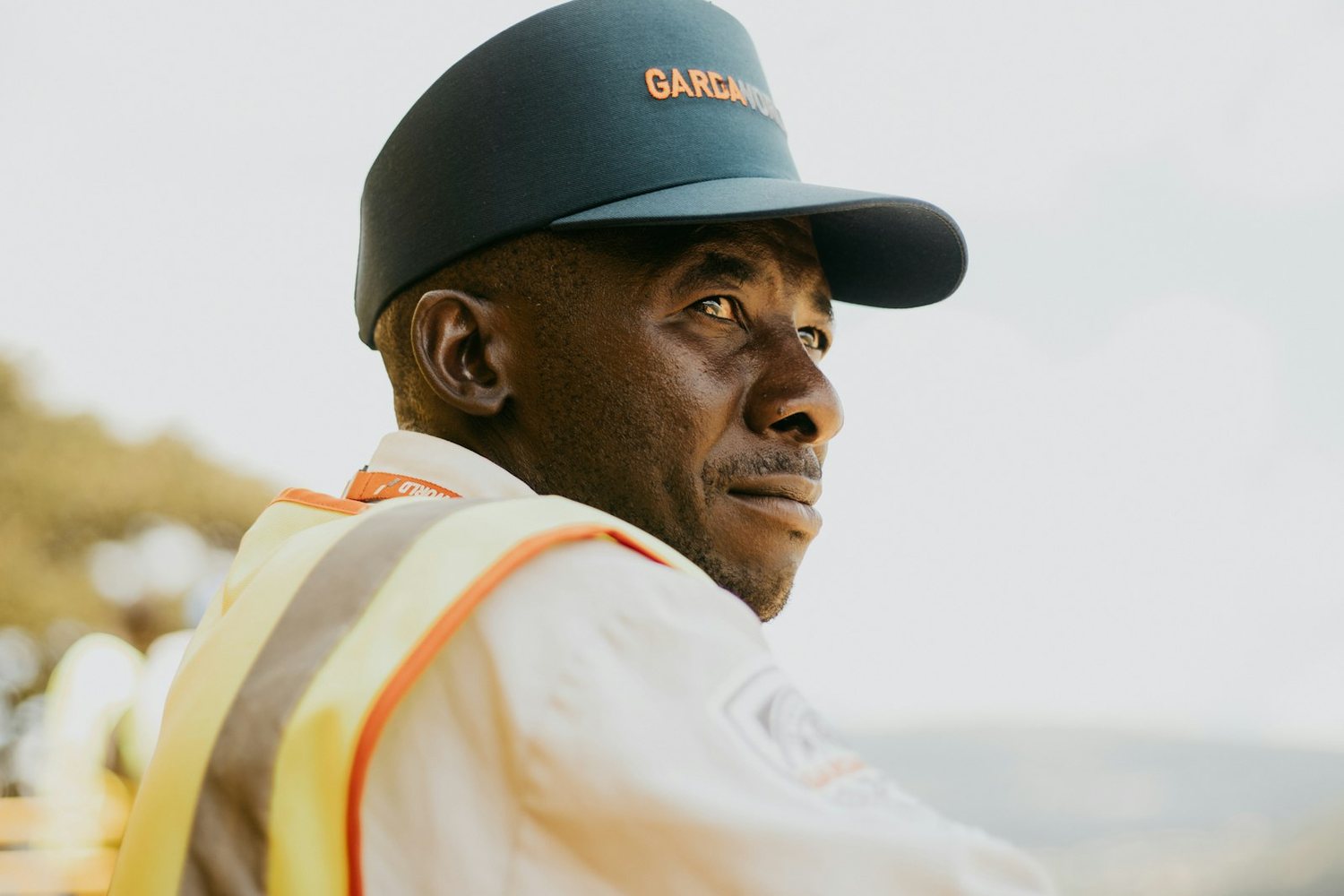 Site worker in high-visibility vest looking across the site