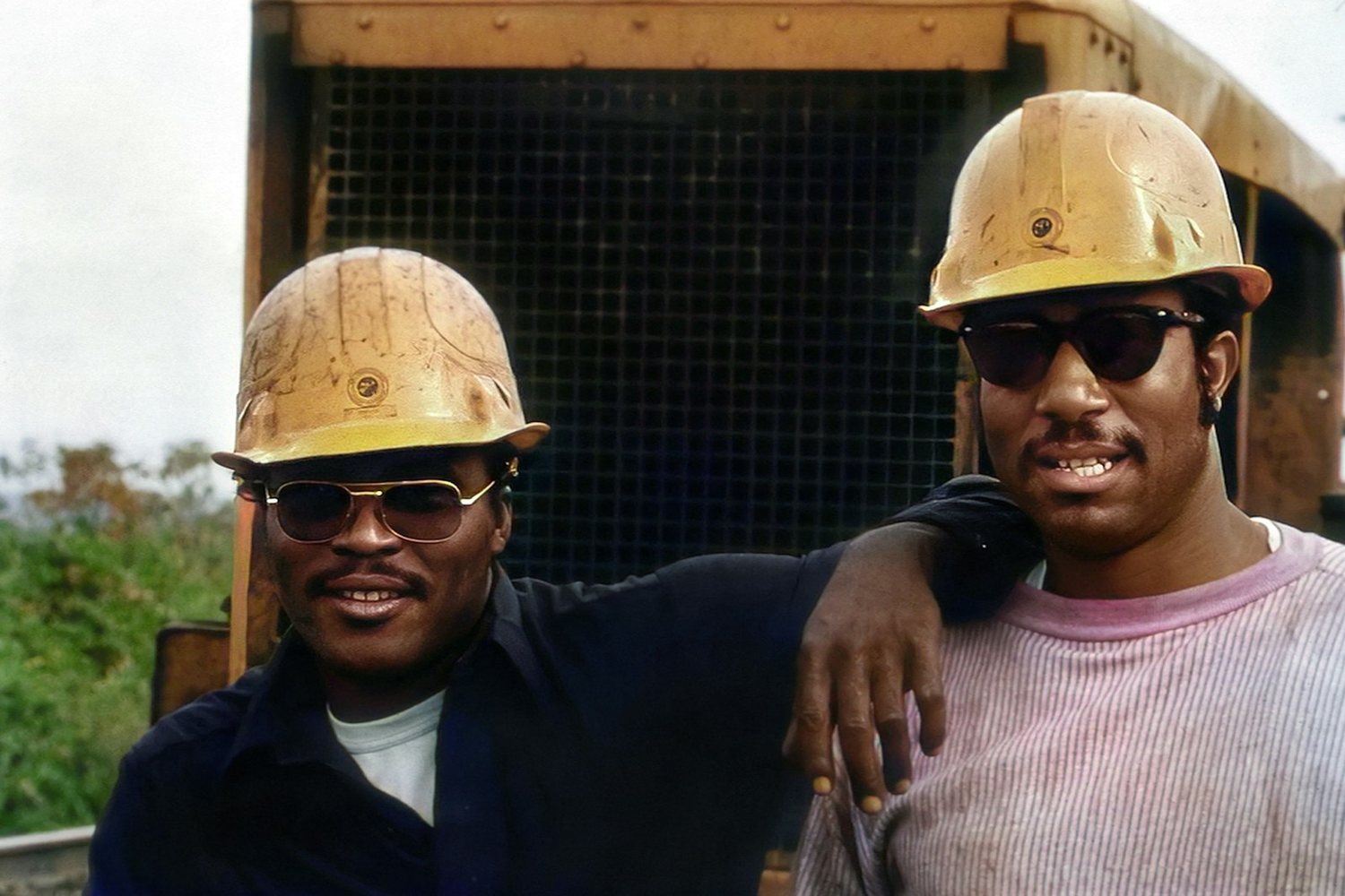 Two construction workers in hard hats on site