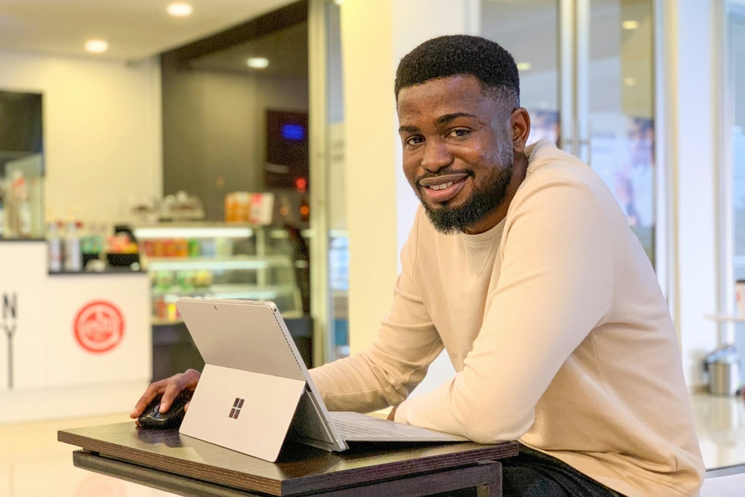Man working on a laptop at a café table