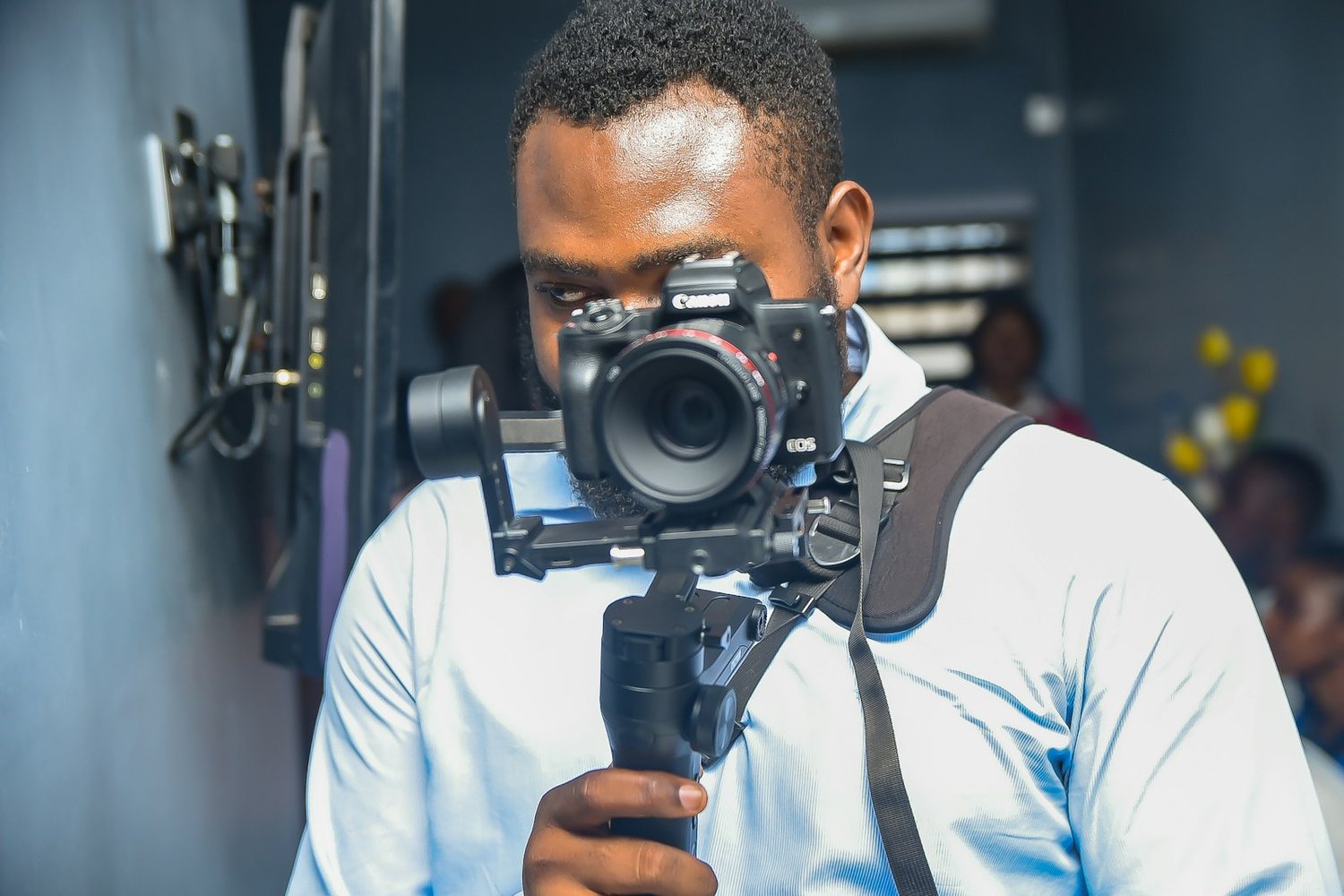 Videographer holding a gimbal-mounted camera