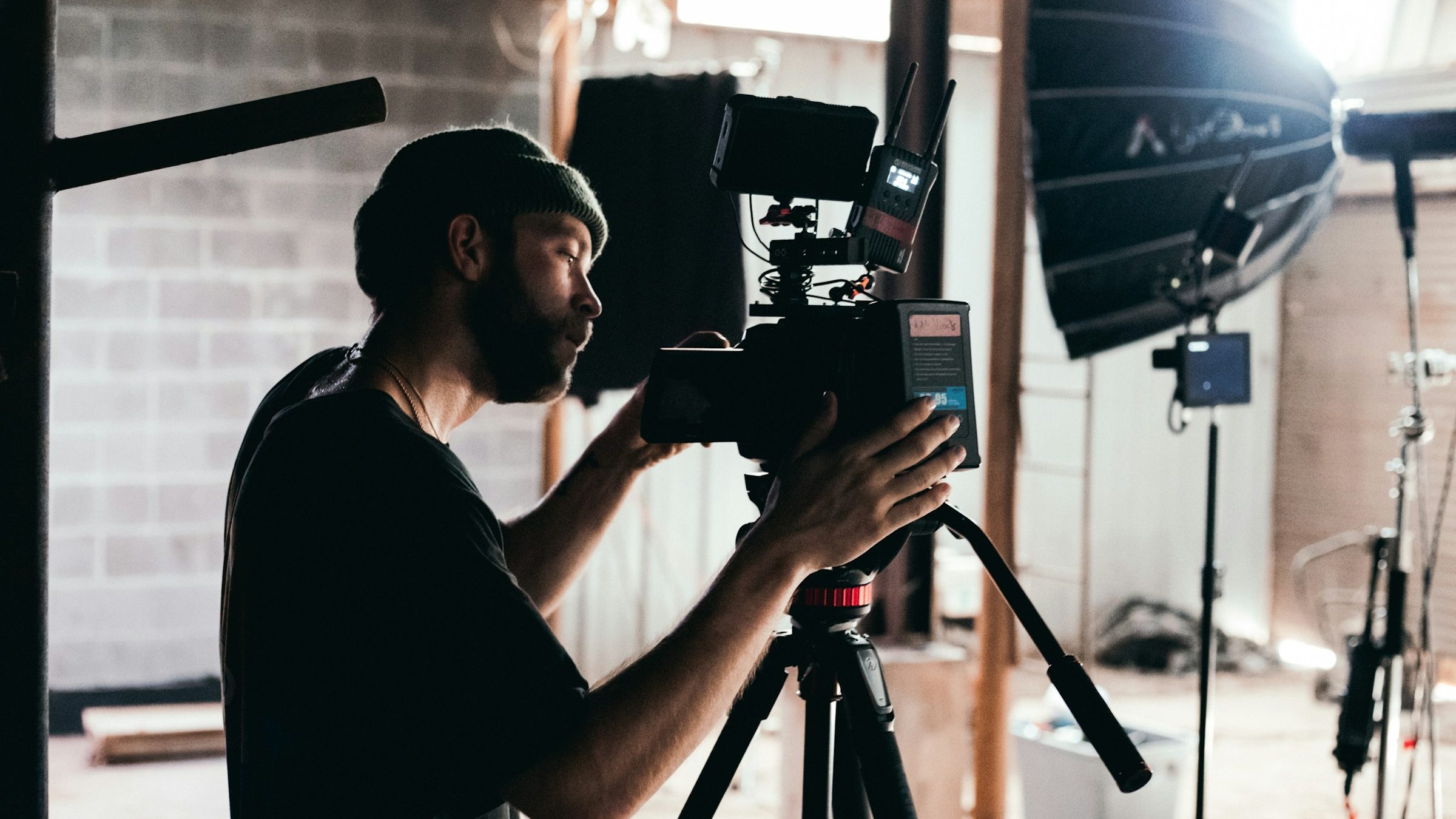 Videographer operating a camera in a studio