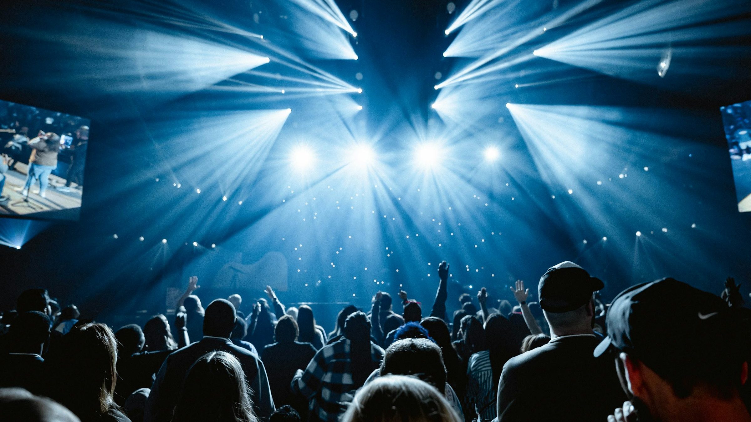 Concert crowd facing a bright stage