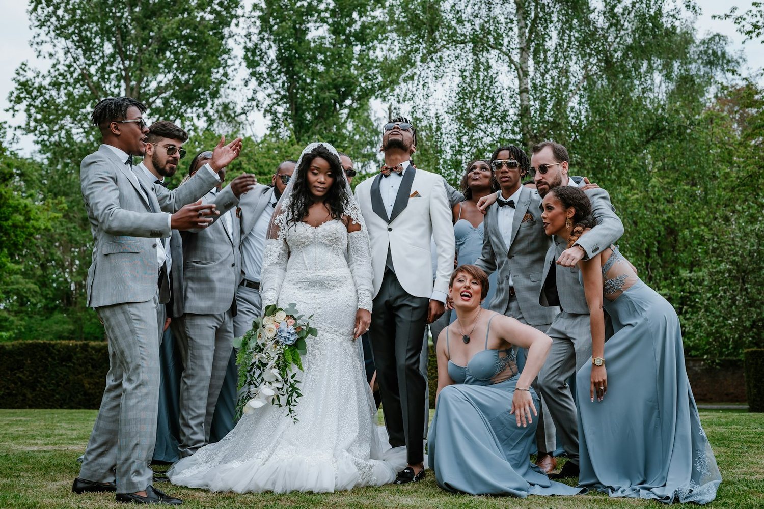 Wedding party posing on a lawn