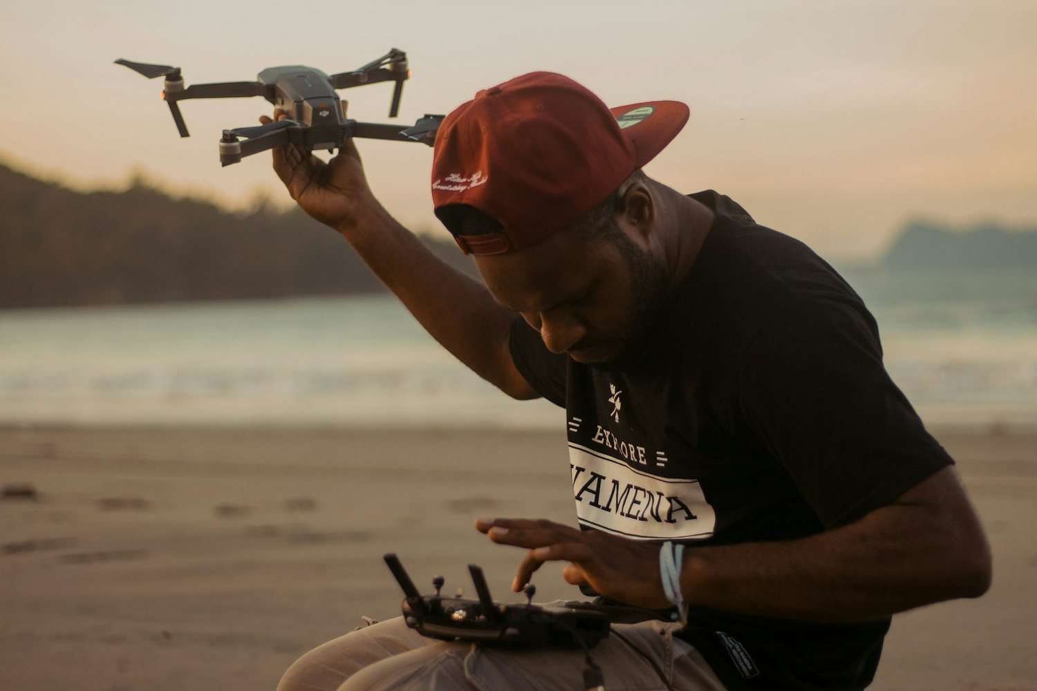 Drone pilot launching a drone at dusk
